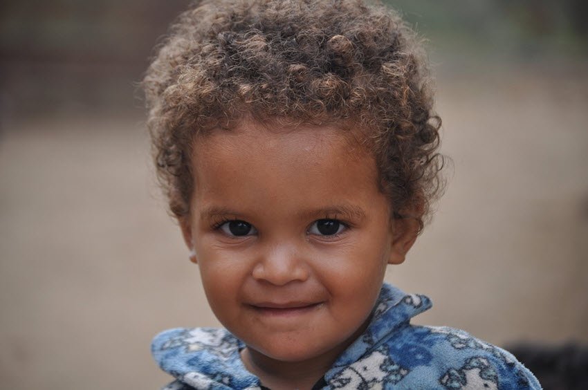 infant with curly hair