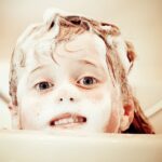 kid taking a bath with soap
