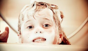 kid taking a bath with soap