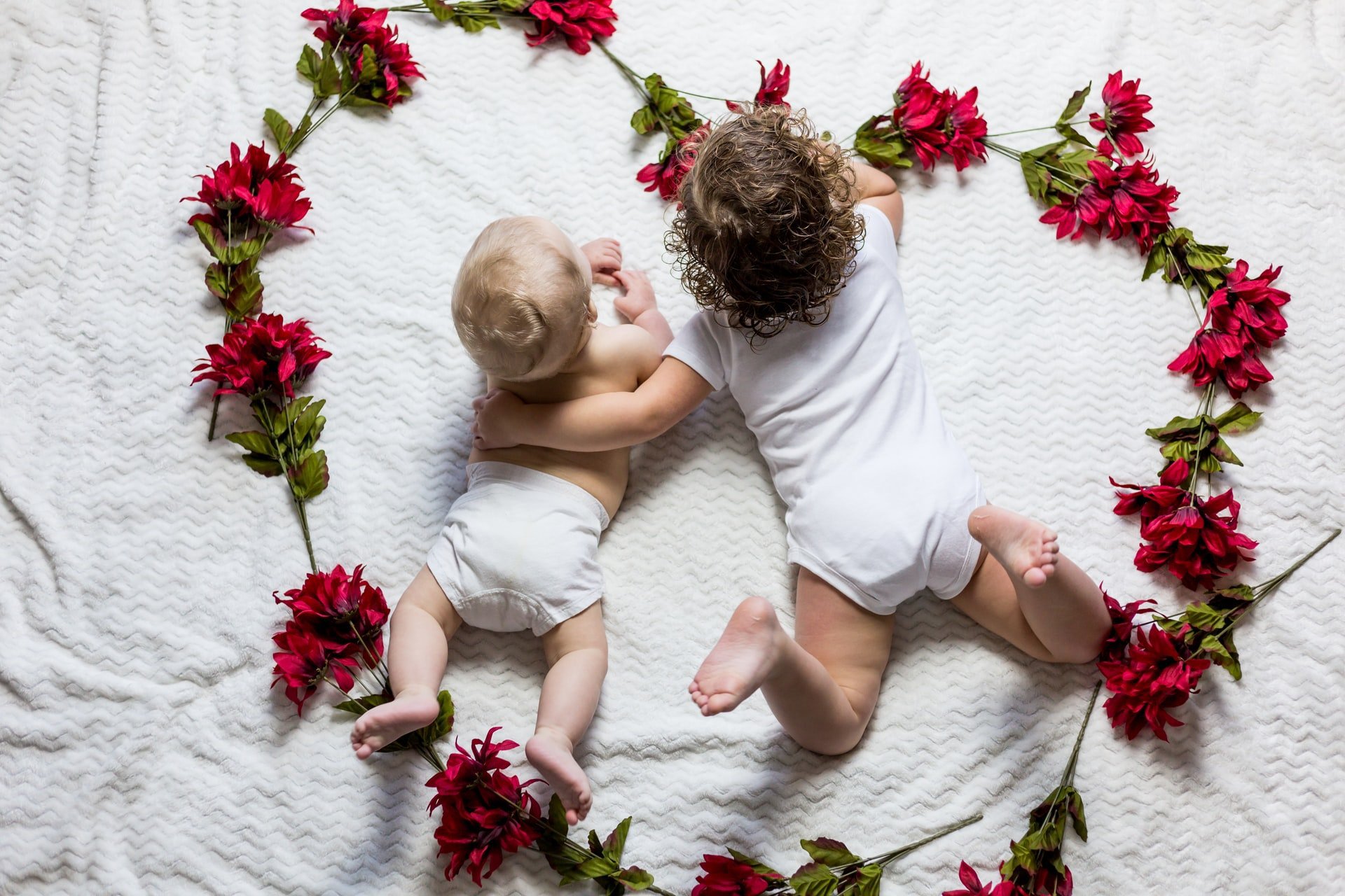 two children surrounded by roses