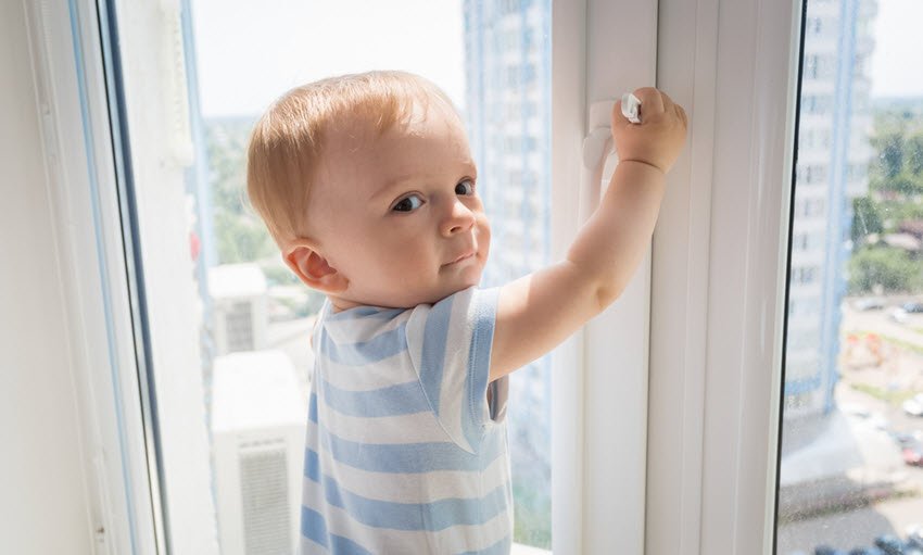 Baby Boy Pulling on Window Handle