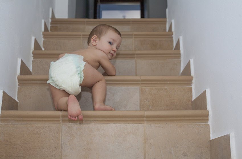 Baby boy crawling up the stairs