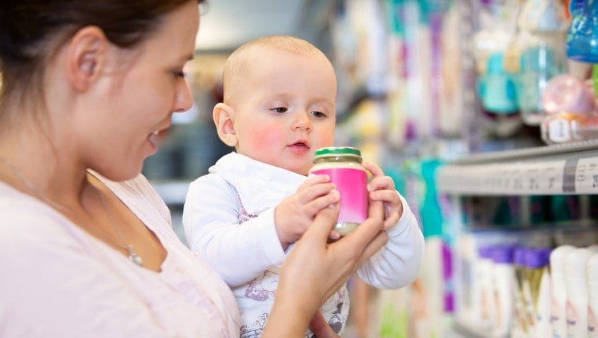 baby looking at product with mom