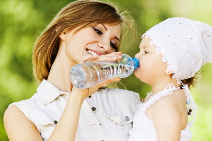 mom giving child water