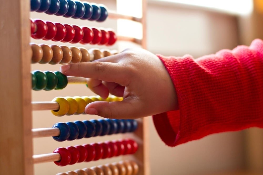 kid counting using an abacus