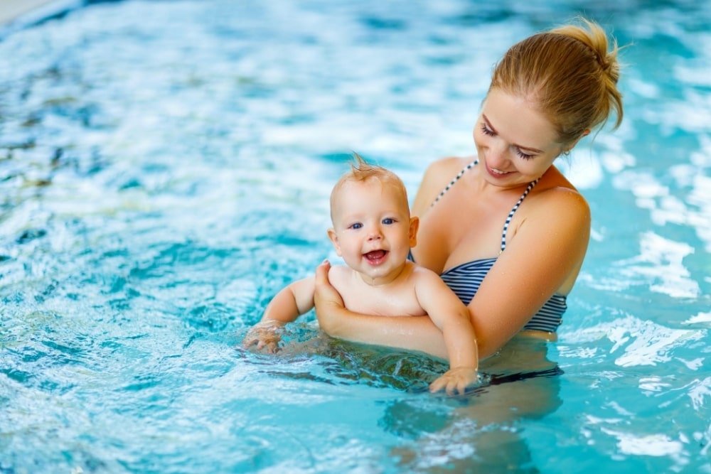 baby with mother in a pool