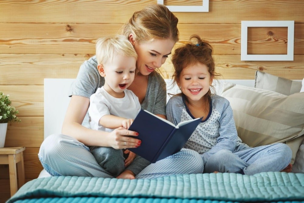 mother reading with young children