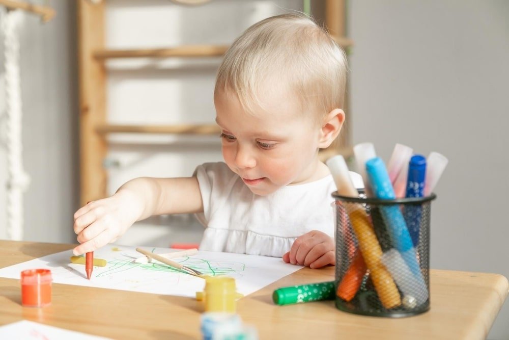 child using crayons