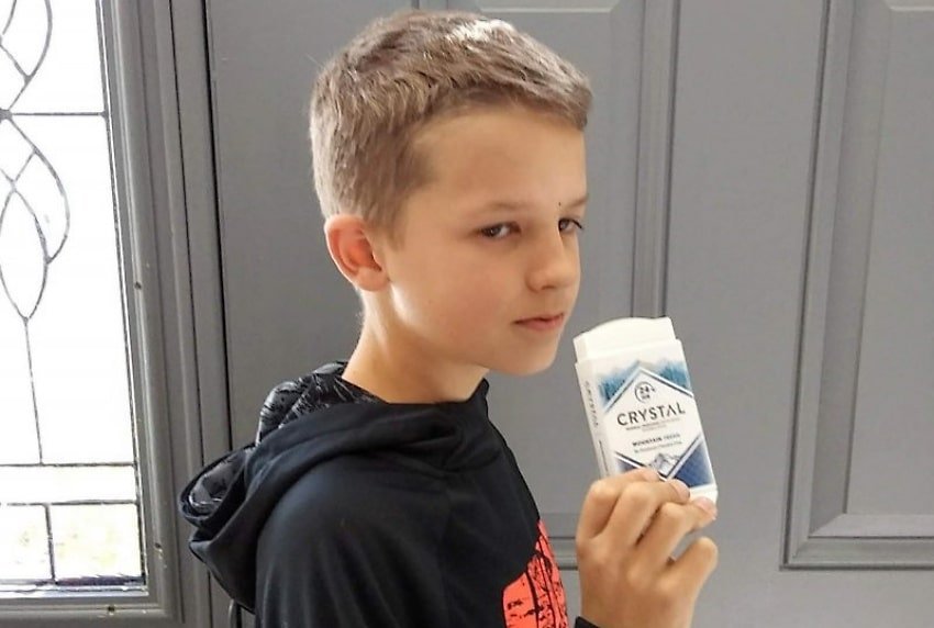 boy holding antiperspirant