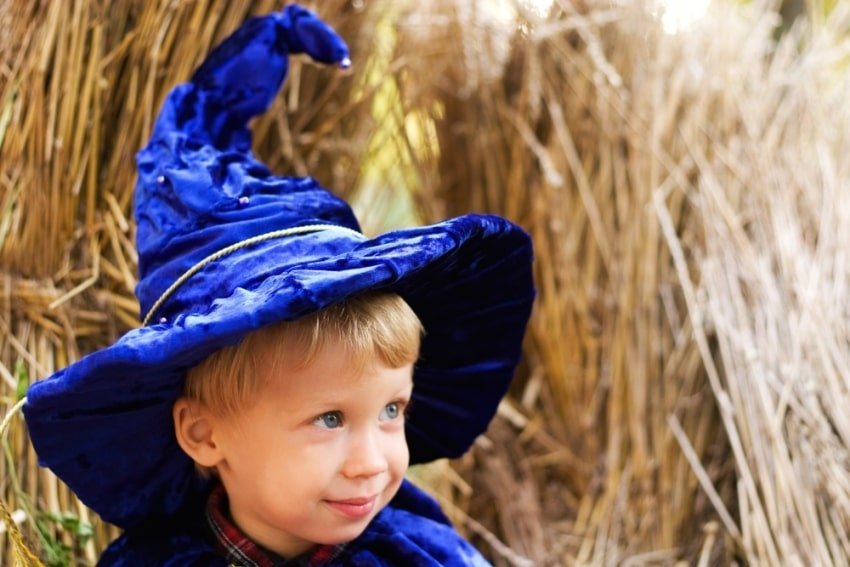 boy wearing in blue wizard hat