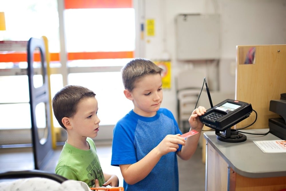 boys processing payment using a credit card