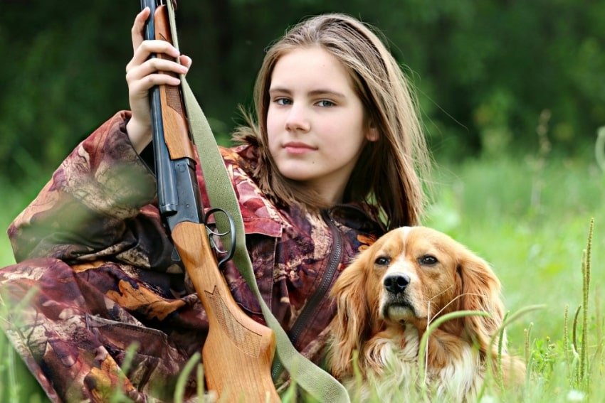 girl and hunting dog
