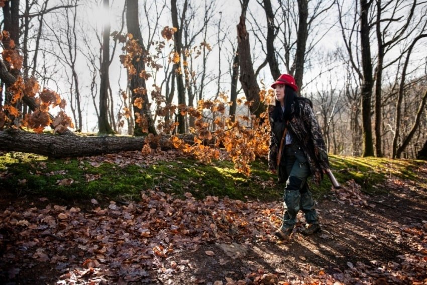woman walking along the woods