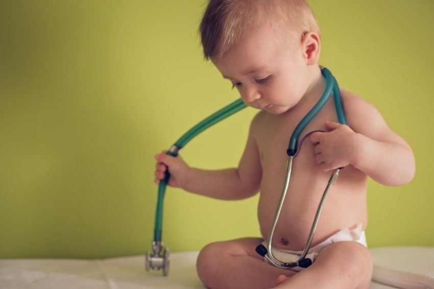 baby boy holding a stethoscope