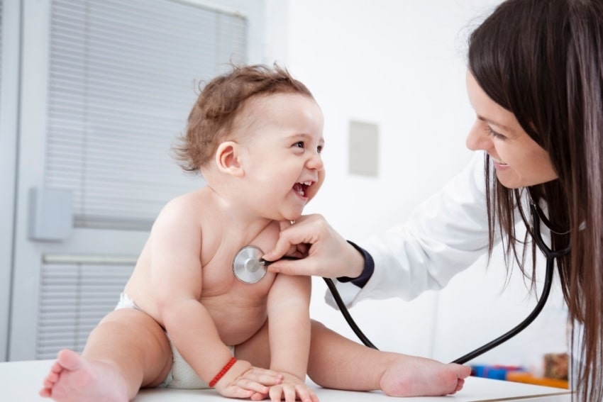 baby smiling at a doctor