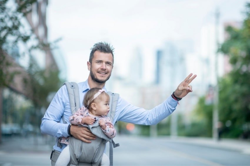father with a baby, hailing a cab