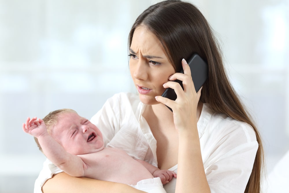 Mother calling to a doctor worried about her baby crying