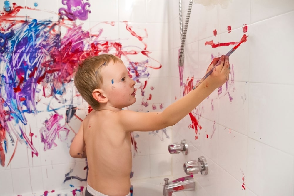 boy drawing on the wall