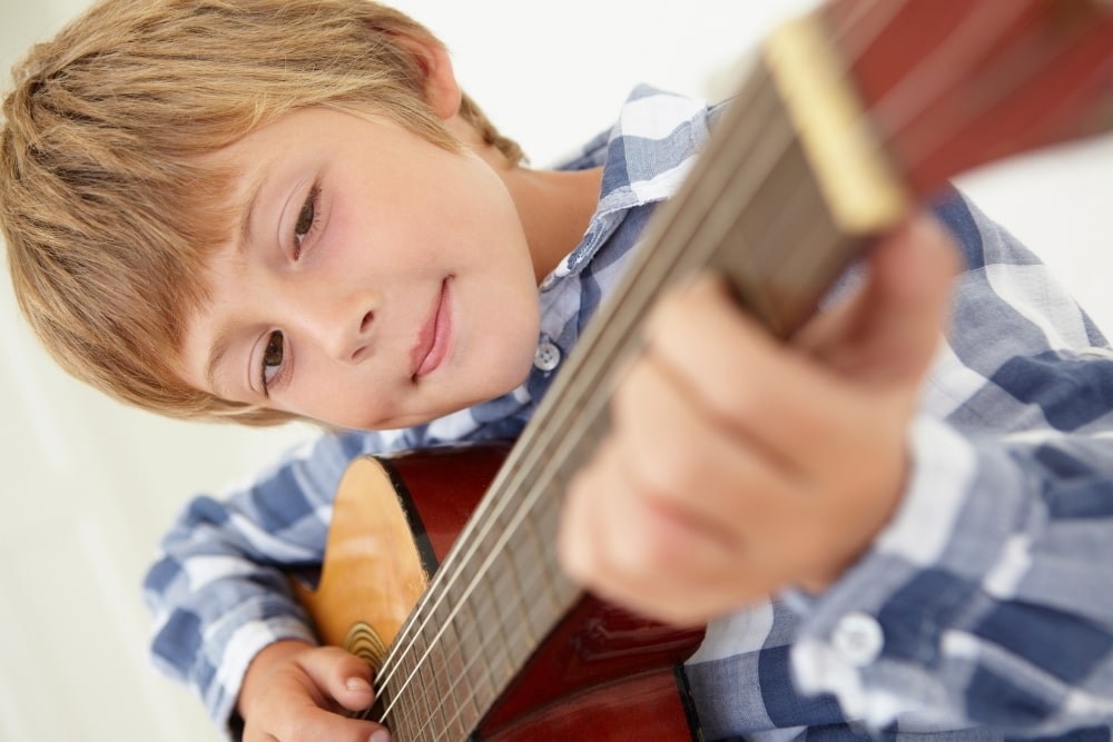 boy holding a guitar