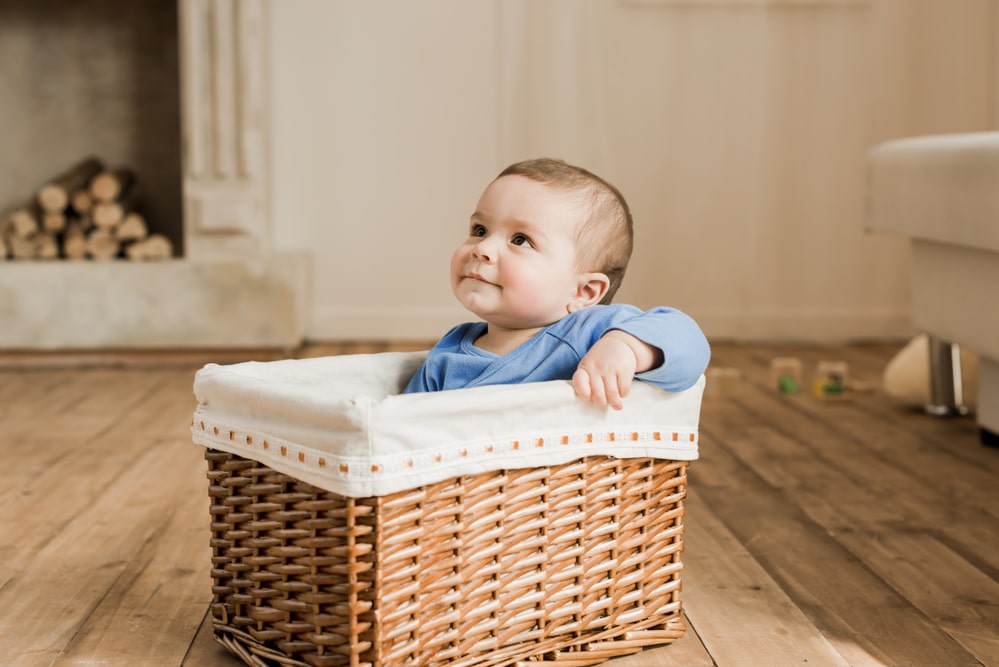 Baby boy sitting in braided box