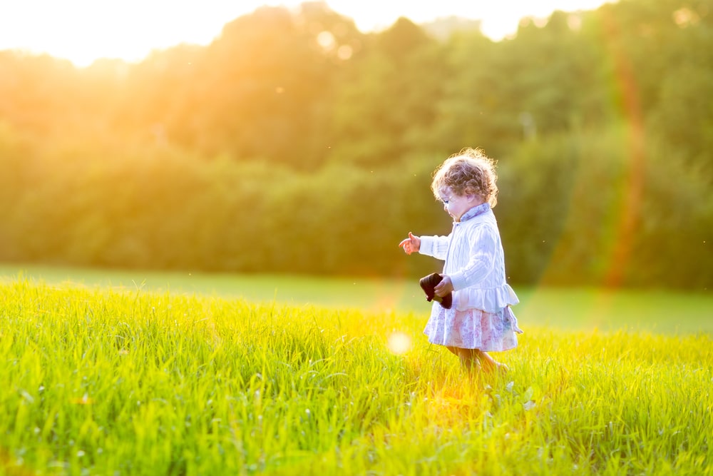 Baby girl walking in an autumn field