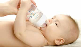Baby holding a milk bottle