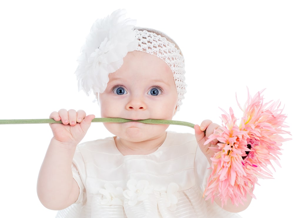 Funny baby girl with flower