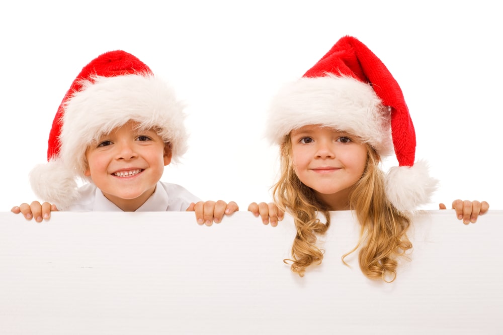 Happy christmas kids with white sign – isolated