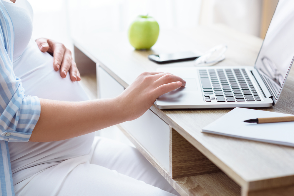 Pregnant woman using laptop
