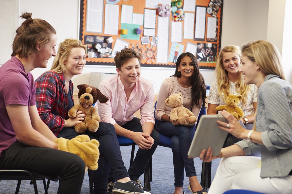Teacher with Students Taking Childcare Course