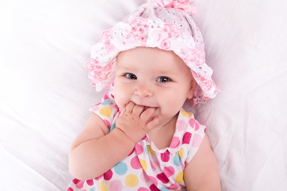 baby wearing pink hat