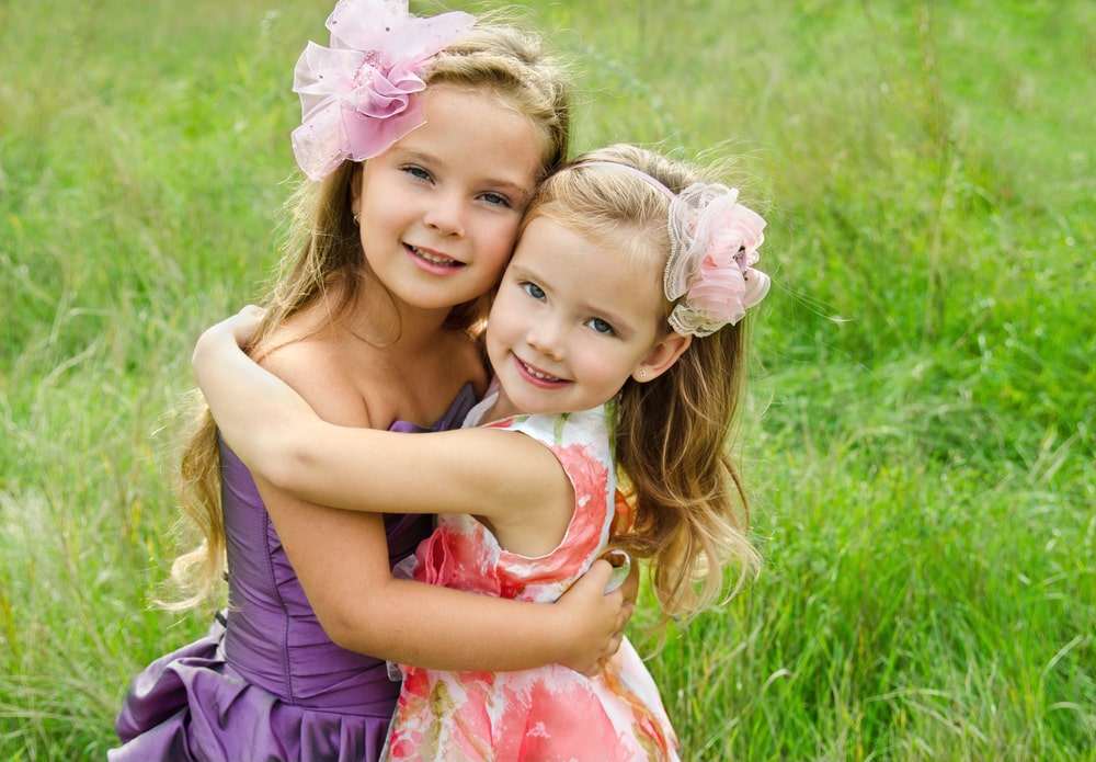 portrait of two embracing cute little girls