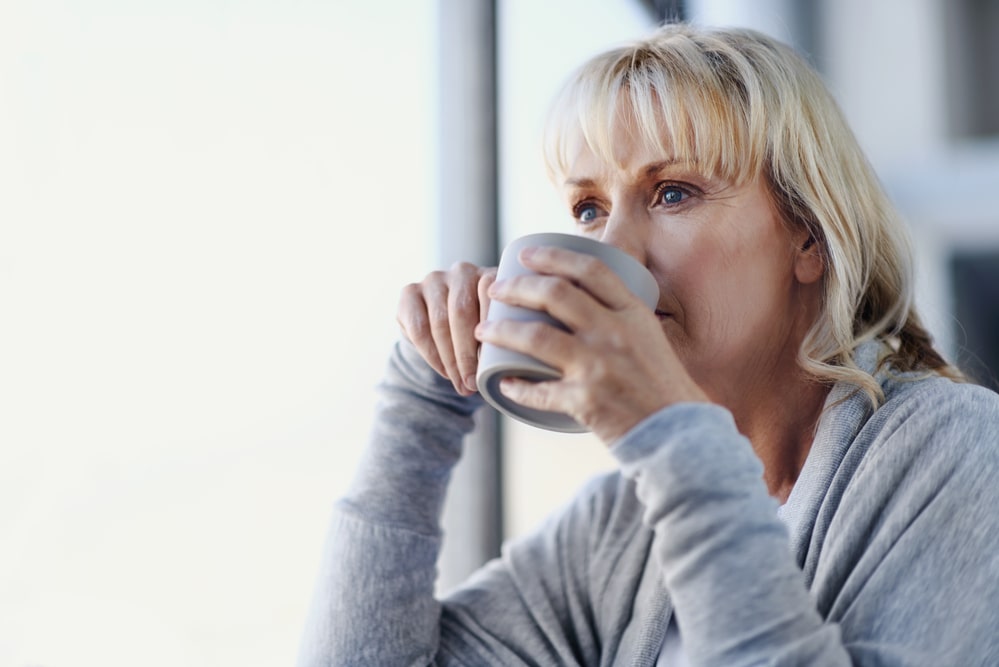 Blonde woman sipping a cup of tea