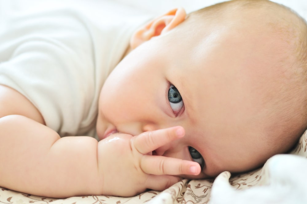 little baby with finger in mouth