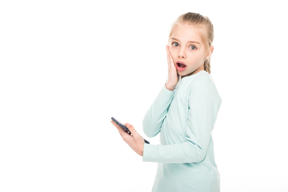 Shocked child with smartphone