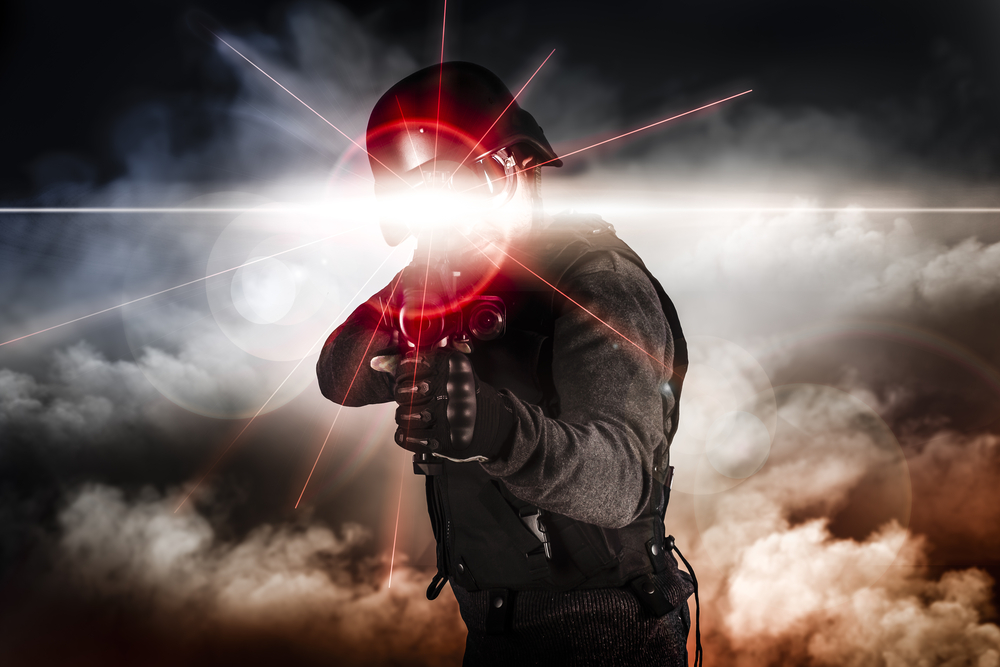 Soldier aiming assault rifle laser sight