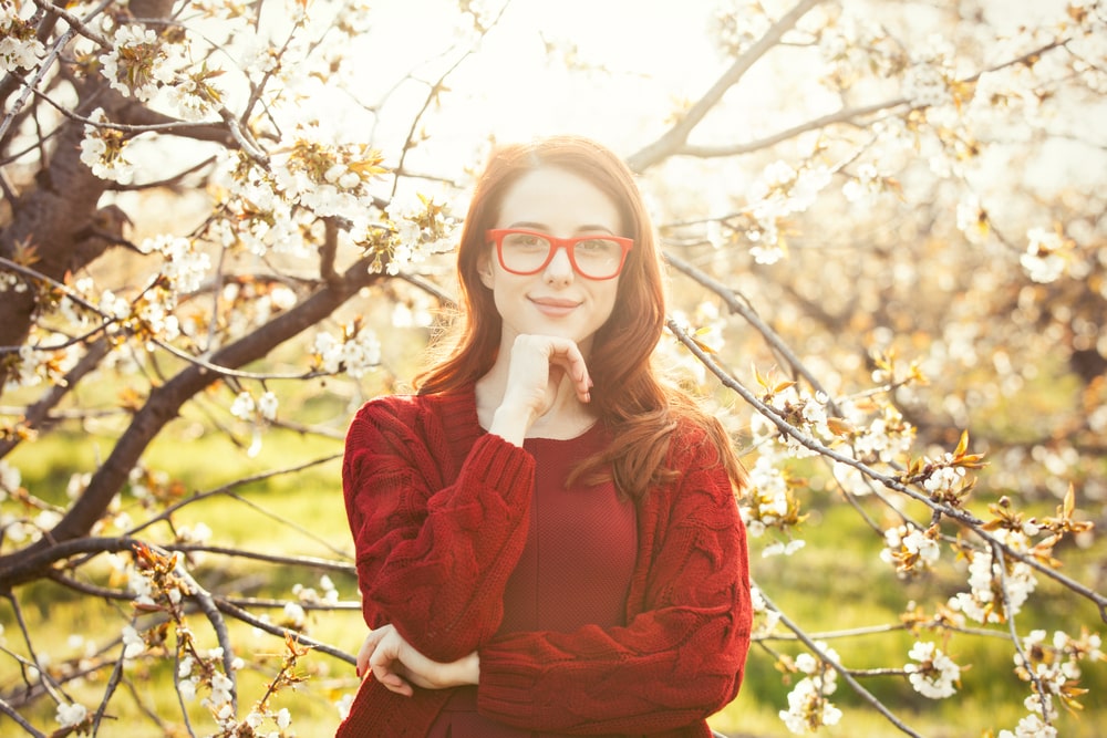 Woman in blossom apple tree garden