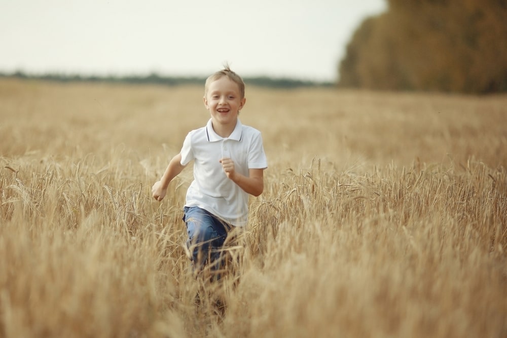 boy running across a field