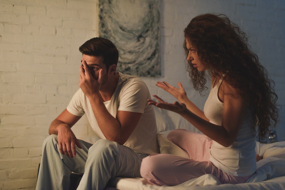 Emotional young woman quarreling with upset boyfriend