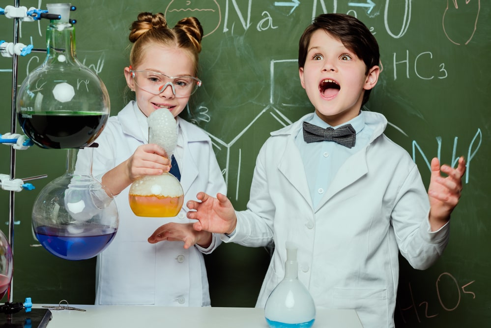 Kids in white coats in laboratory