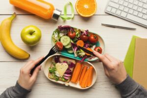 Woman eating healthy dinner from lunch box