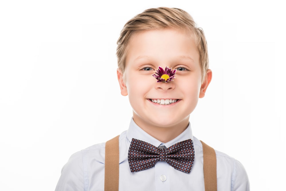 Boy with flower on nose
