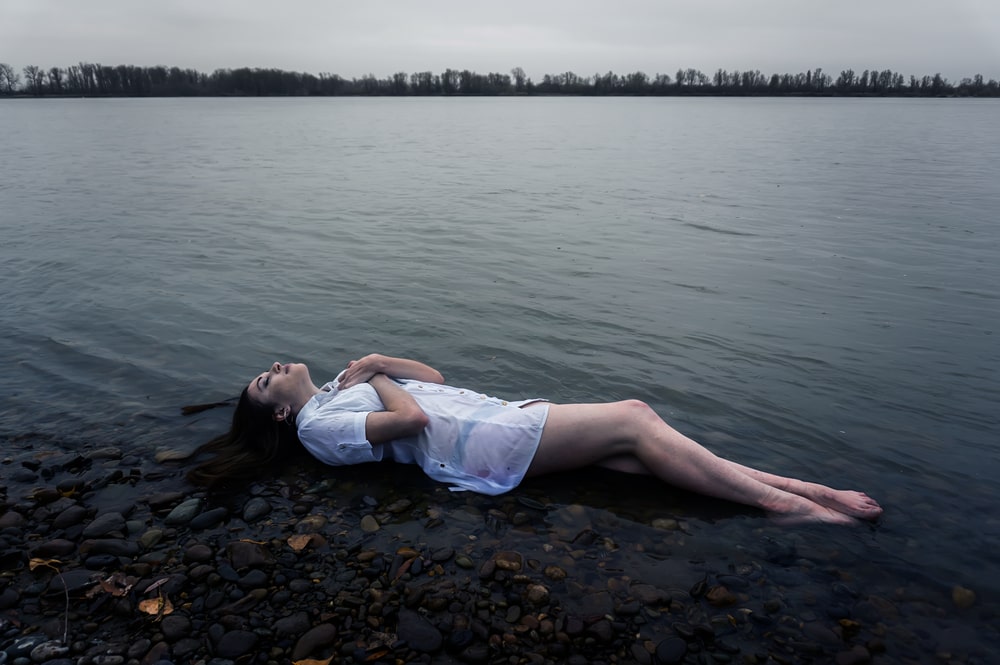 Floating girl in dark river