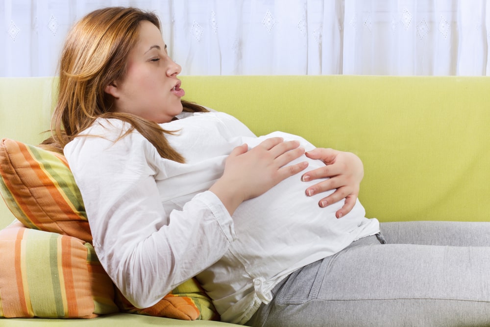 Pregnant woman doing breathing exercises