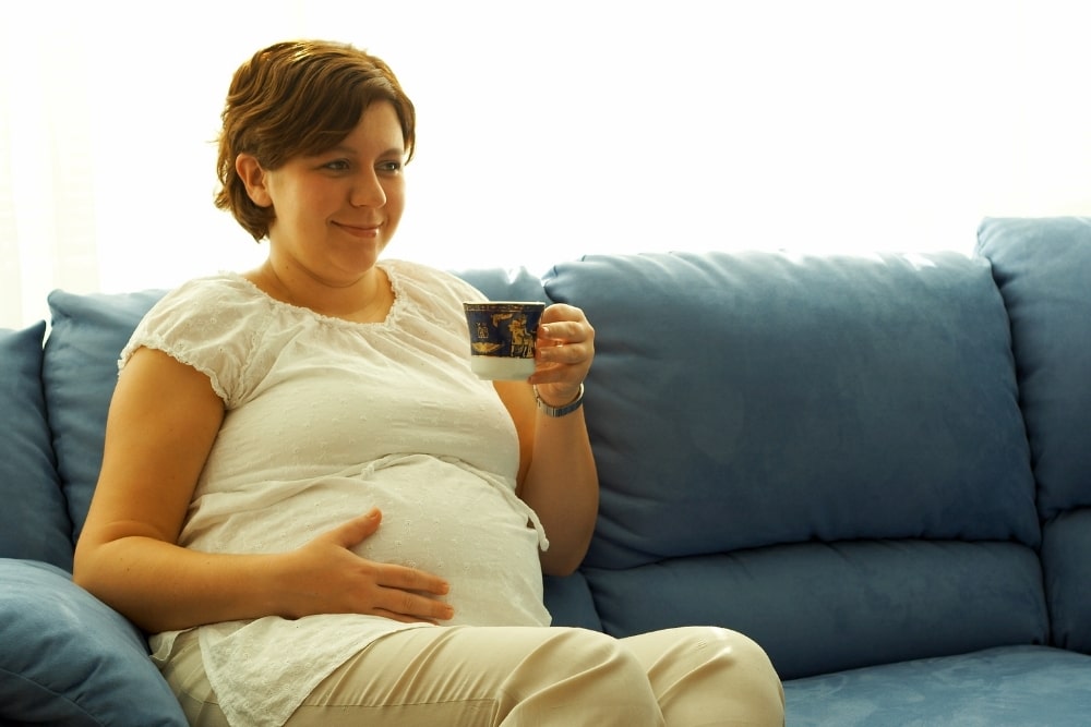 pregnant woman drinking coffee