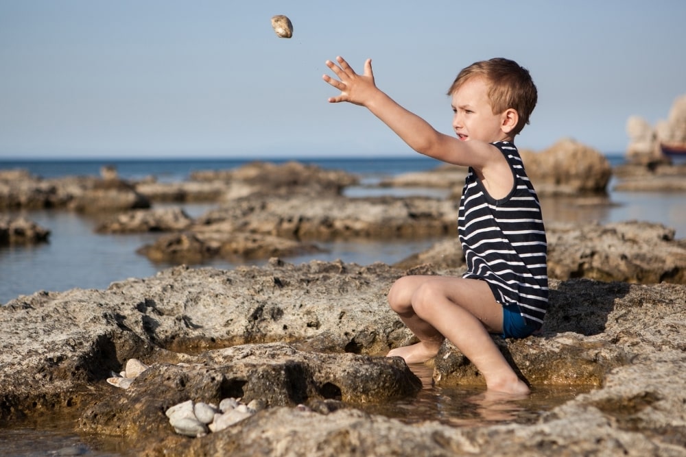 boy throwing rocks