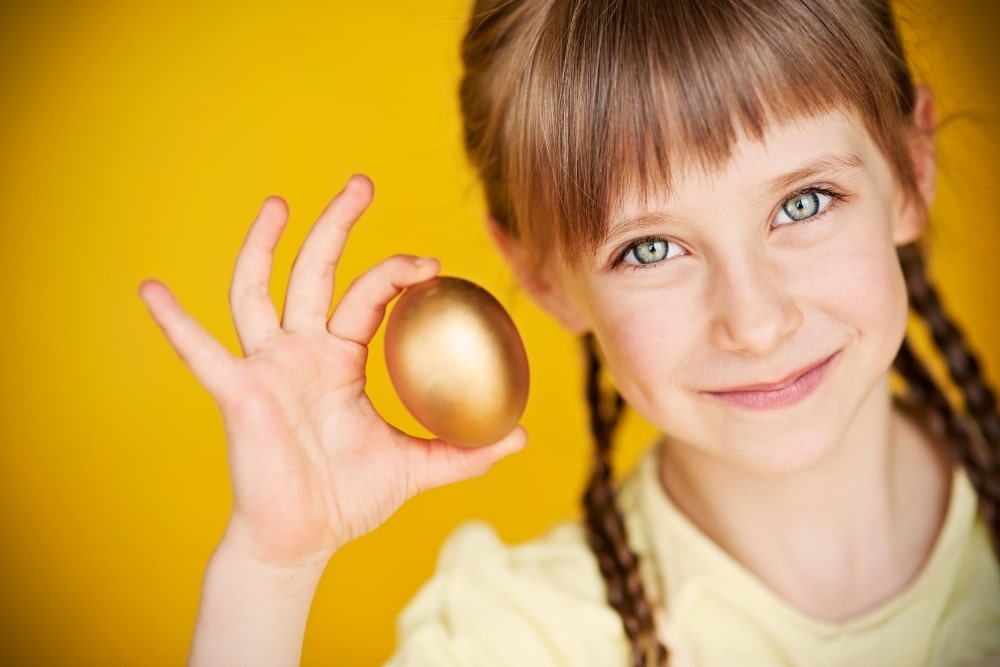 girl holding golden egg