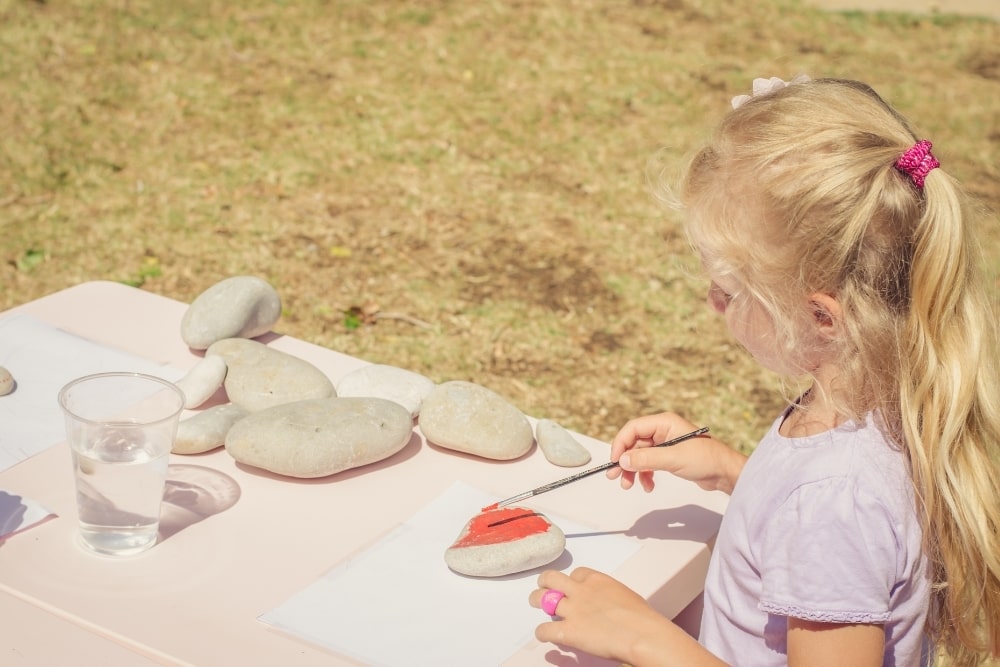 little girl paint stones