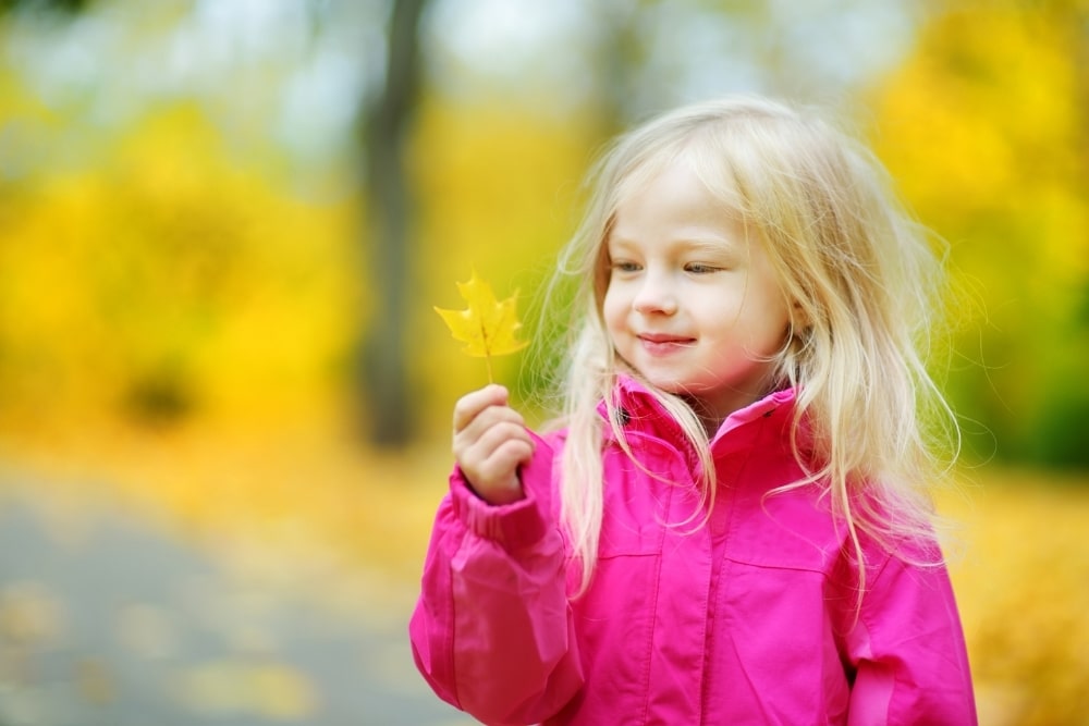 little girl outdoor pink jacket smile