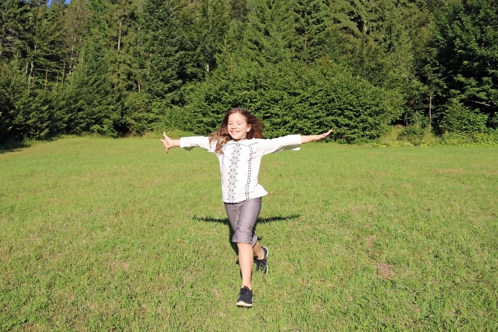 little girl running outdoors